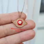 Ροζ ασημένιο κολιέ με ματάκι και λευκές πέτρες.