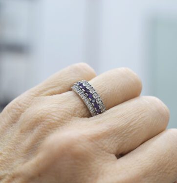 Ασημένιο δαχτυλίδι με μπλε-μωβ και λευκές πέτρες.